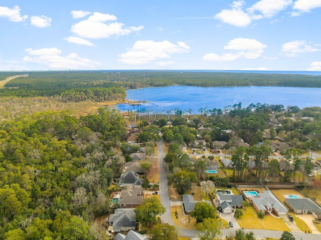 aerial view with a forest view and a water view