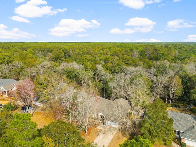 drone / aerial view with a wooded view