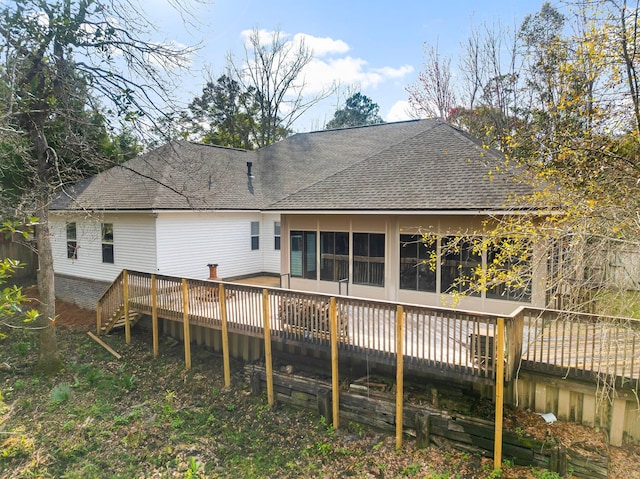 back of property featuring roof with shingles and a wooden deck