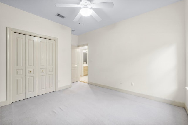 unfurnished bedroom with baseboards, visible vents, ceiling fan, carpet floors, and a closet