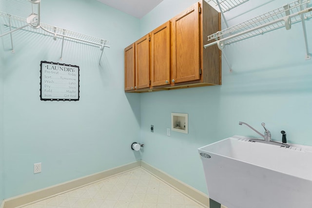 clothes washing area with light floors, cabinet space, a sink, electric dryer hookup, and baseboards