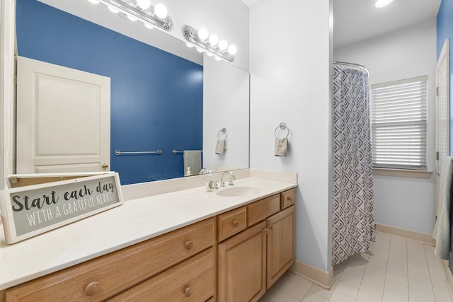 full bathroom featuring tile patterned floors, baseboards, and vanity