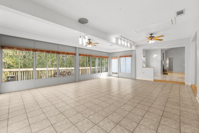 unfurnished living room featuring a ceiling fan, visible vents, and light tile patterned floors