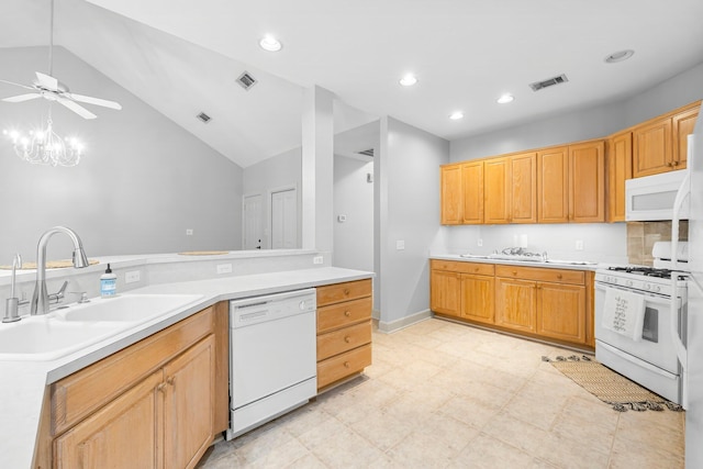 kitchen with light countertops, white appliances, visible vents, and a sink