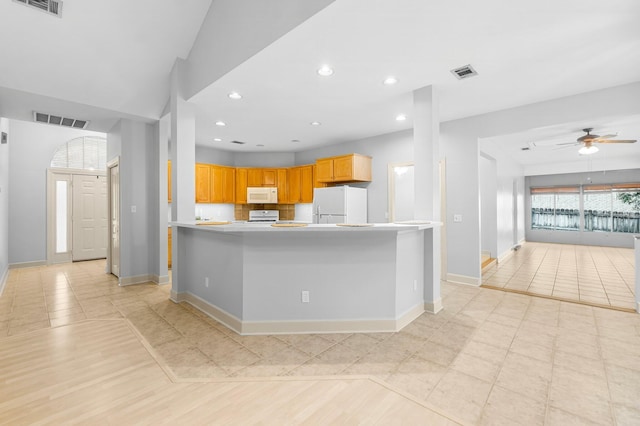 kitchen with light countertops, white appliances, visible vents, and recessed lighting