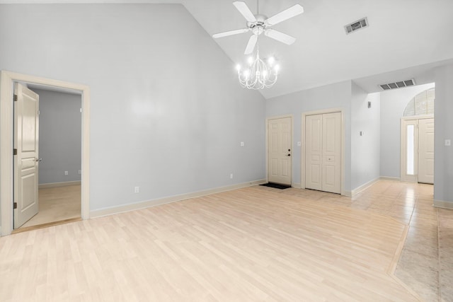 spare room with high vaulted ceiling, visible vents, and light wood-style floors