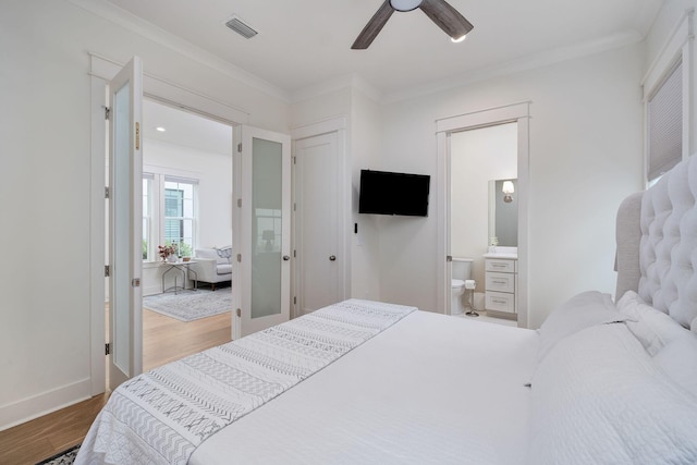 bedroom with baseboards, visible vents, a ceiling fan, ornamental molding, and wood finished floors