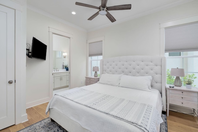 bedroom with crown molding, recessed lighting, light wood-style flooring, ensuite bath, and baseboards