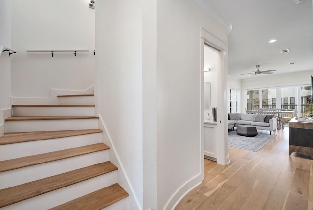 stairs featuring baseboards, visible vents, a ceiling fan, wood-type flooring, and recessed lighting