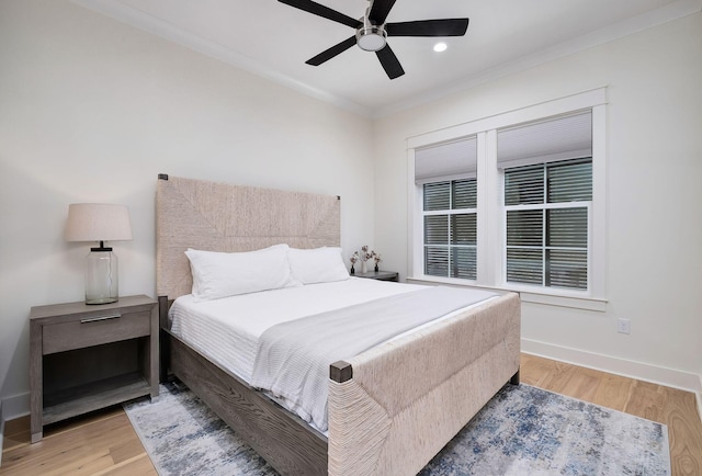 bedroom with ceiling fan, baseboards, wood finished floors, and ornamental molding