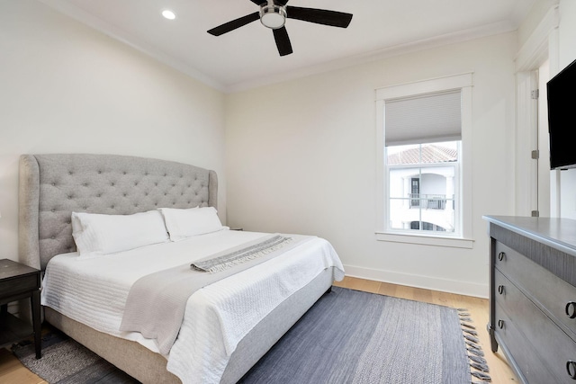 bedroom featuring baseboards, a ceiling fan, light wood-style flooring, crown molding, and recessed lighting