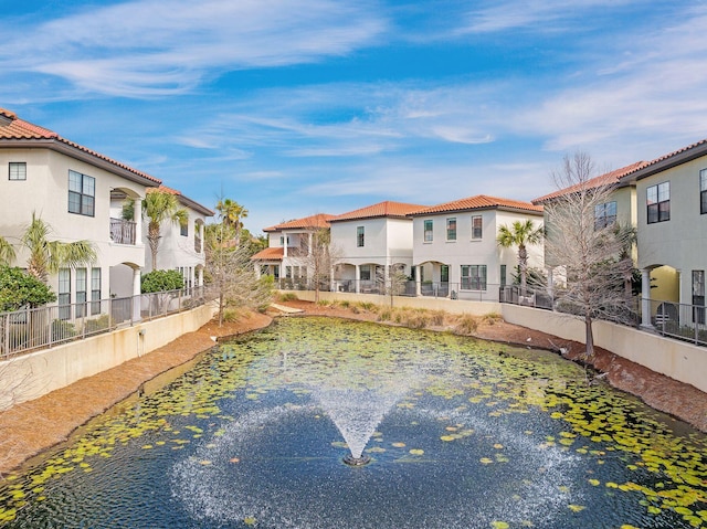 view of pool featuring a residential view and fence