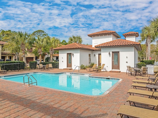 back of property featuring fence, a patio, and stucco siding