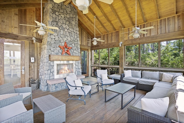 exterior space featuring wood ceiling, hardwood / wood-style floors, wood walls, a fireplace, and beam ceiling