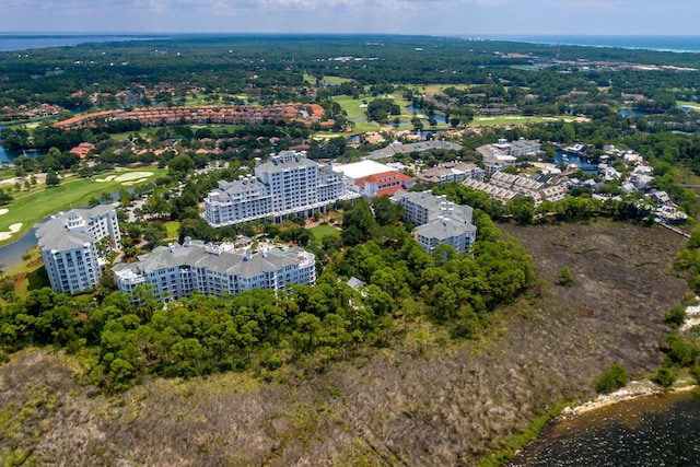 birds eye view of property with a water view and golf course view