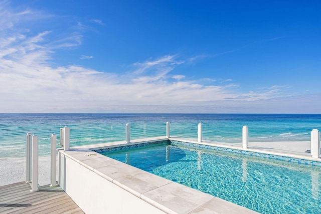 view of pool with a water view