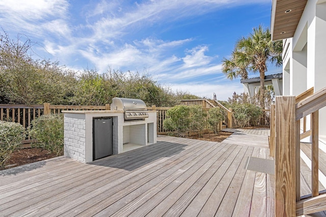 deck with exterior kitchen and area for grilling