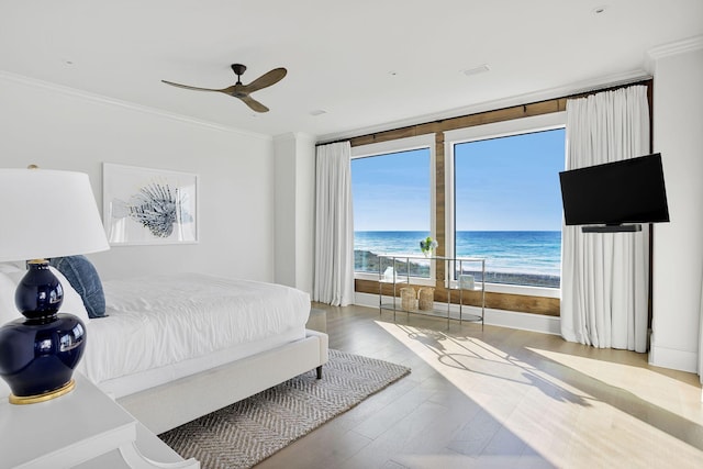 bedroom with access to exterior, a ceiling fan, crown molding, and wood finished floors