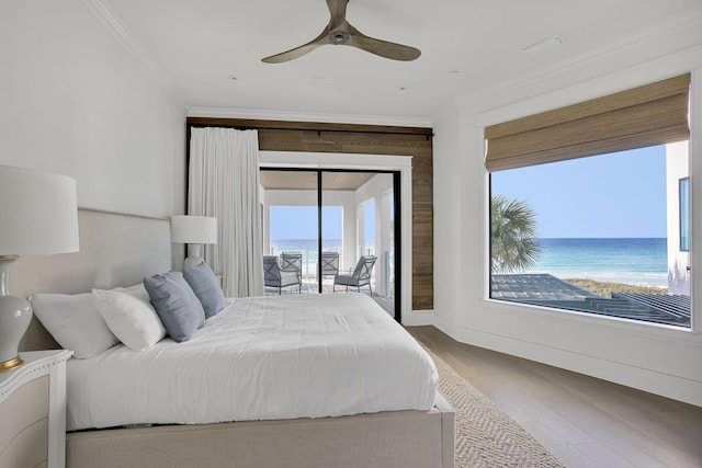 bedroom with access to exterior, multiple windows, crown molding, and wood finished floors