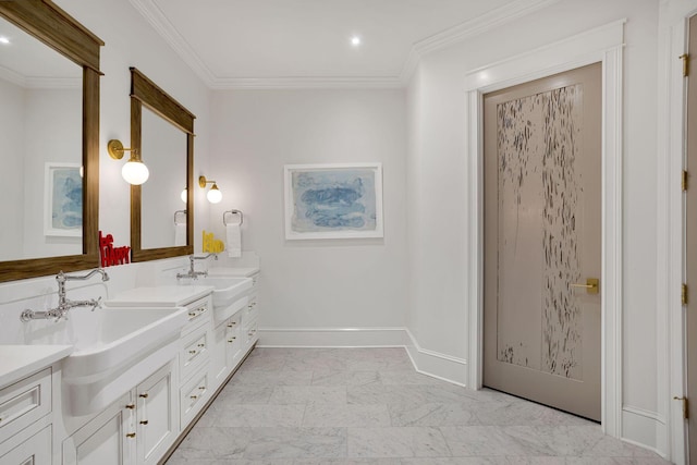 bathroom featuring marble finish floor, crown molding, and a sink