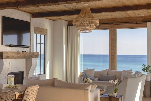 living room with a chandelier, wooden ceiling, and a healthy amount of sunlight