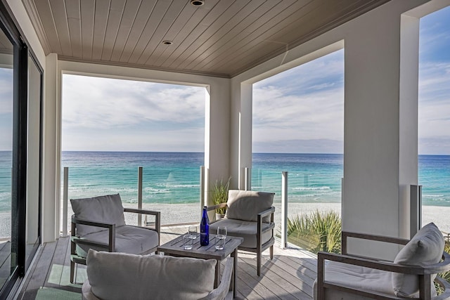 balcony with a water view and a beach view