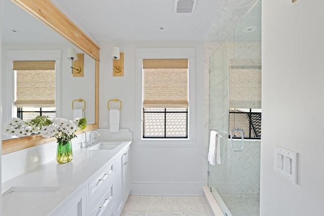 full bathroom with double vanity, visible vents, a stall shower, a sink, and baseboards