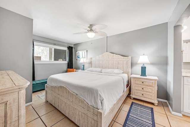 bedroom with light tile patterned floors, ceiling fan, and baseboards