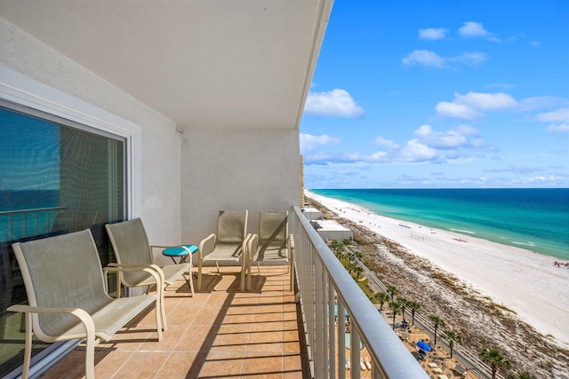 balcony featuring a beach view and a water view