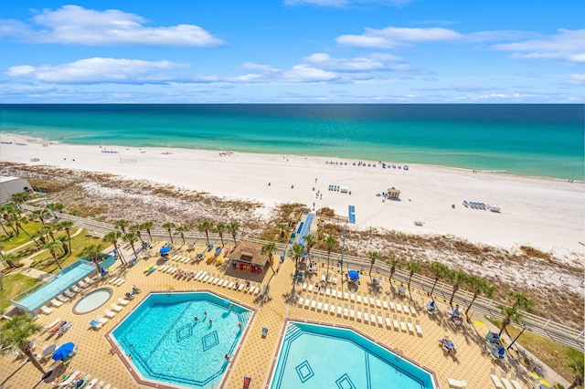 aerial view with a water view and a beach view