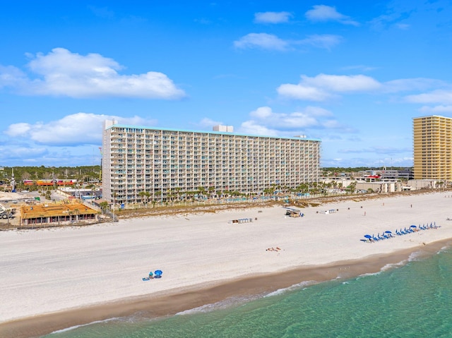 aerial view featuring a view of city, a water view, and a beach view