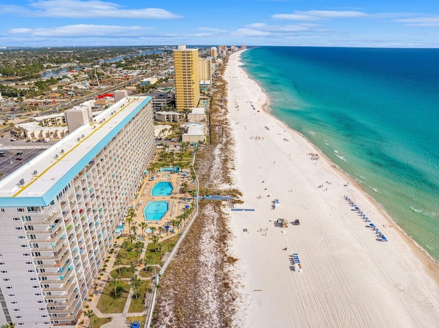 drone / aerial view featuring a city view, a beach view, and a water view