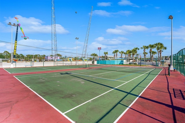 view of sport court featuring fence