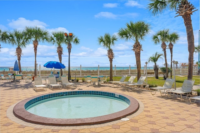 view of swimming pool featuring a patio area and fence