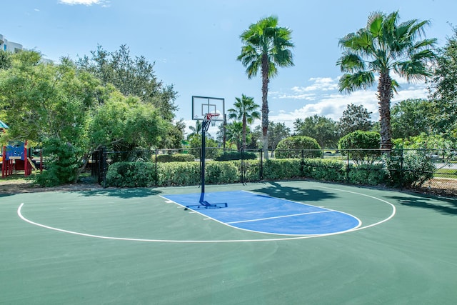 view of basketball court with community basketball court, playground community, and fence