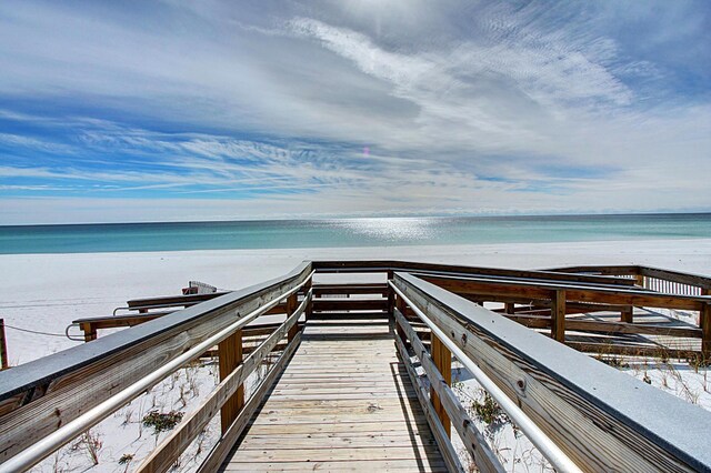 view of home's community with a water view and a view of the beach