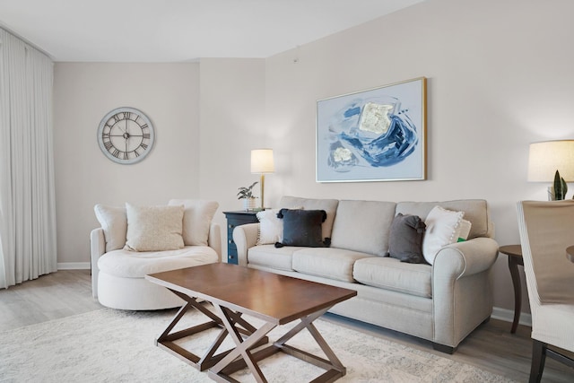 living area with light wood-style floors and baseboards