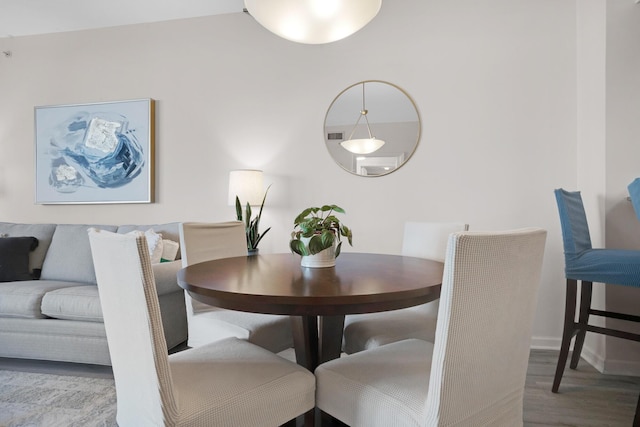 dining space with wood finished floors