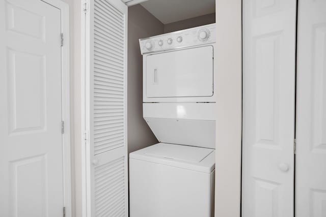 laundry area featuring laundry area and stacked washer / drying machine