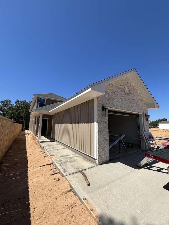 110 2nd Ave, Shalimar, FL 32579 - exterior space with concrete driveway, brick siding, fence, and a garage