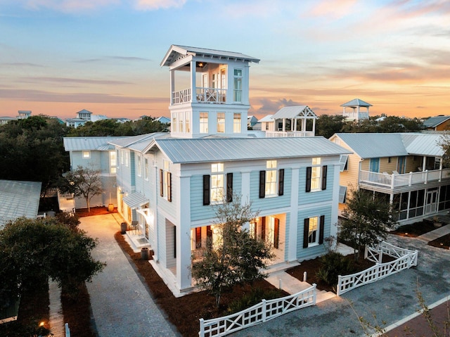 35 Tupelo St, Santa Rosa Beach, FL 32459 - view of front of house featuring driveway, fence private yard, metal roof, and a balcony