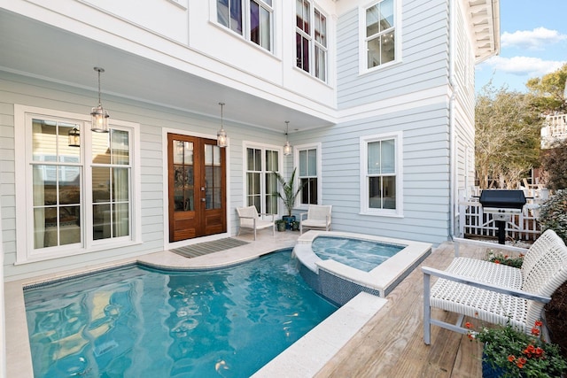 35 Tupelo St, Santa Rosa Beach, FL 32459 - view of swimming pool featuring french doors, a patio, a pool with connected hot tub, and area for grilling