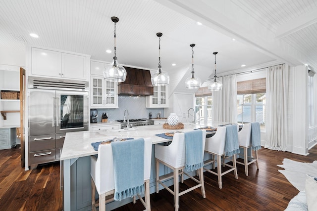 35 Tupelo St, Santa Rosa Beach, FL 32459 - kitchen with backsplash, a large island with sink, built in refrigerator, custom exhaust hood, and dark wood-style floors