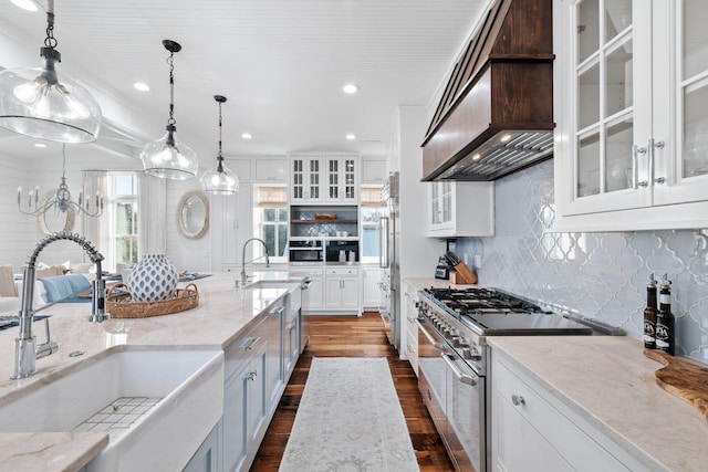 35 Tupelo St, Santa Rosa Beach, FL 32459 - kitchen with a sink, range with two ovens, white cabinetry, custom range hood, and dark wood-style floors