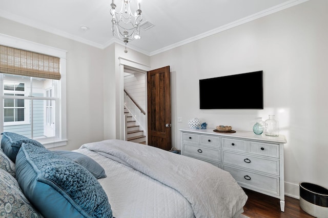 35 Tupelo St, Santa Rosa Beach, FL 32459 - bedroom with crown molding, an inviting chandelier, baseboards, visible vents, and dark wood-style floors
