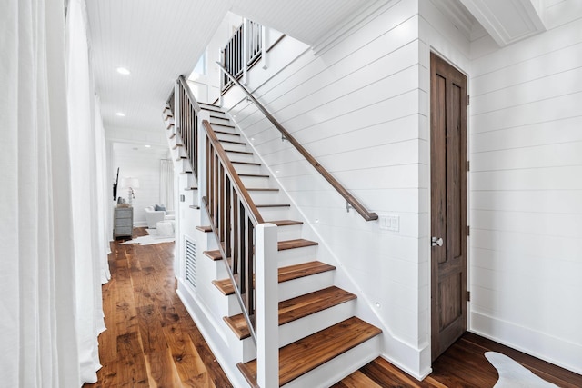 35 Tupelo St, Santa Rosa Beach, FL 32459 - staircase with recessed lighting, wooden walls, and hardwood / wood-style flooring