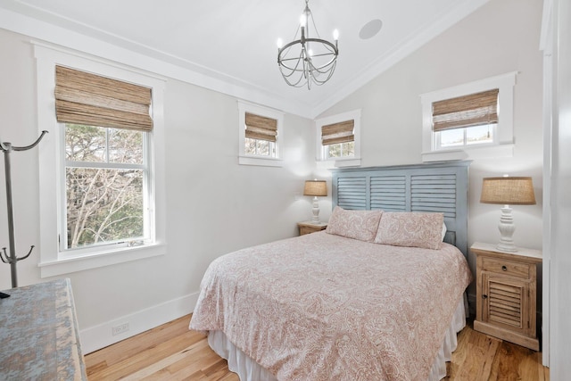 35 Tupelo St, Santa Rosa Beach, FL 32459 - bedroom featuring an inviting chandelier, baseboards, wood finished floors, and lofted ceiling