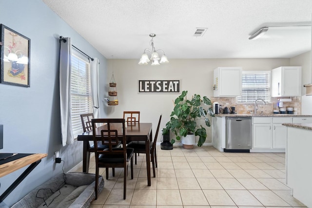 dining space with plenty of natural light, visible vents, and light tile patterned floors