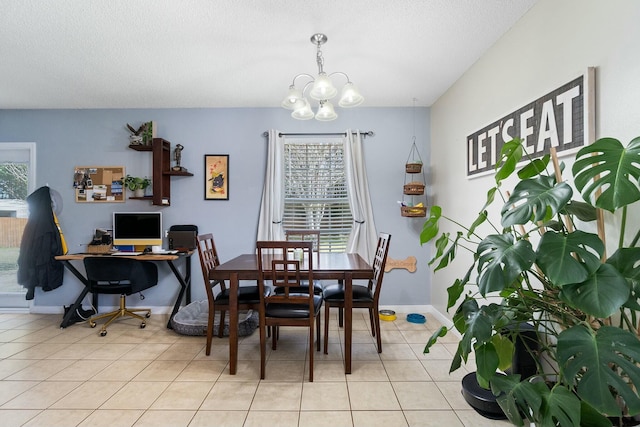 dining room with a notable chandelier, light tile patterned flooring, baseboards, and a textured ceiling