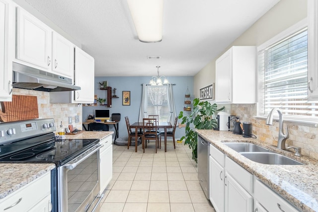 kitchen with visible vents, under cabinet range hood, light tile patterned floors, stainless steel appliances, and a sink